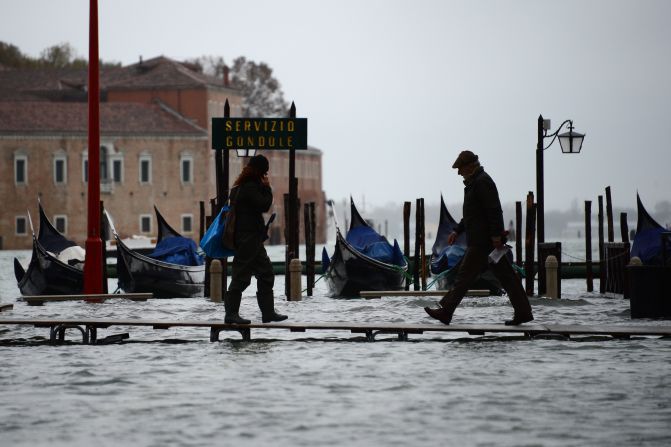The "acqua alta'" (high waters) left tourists clambering across hastily constructed bridges to get around the city.