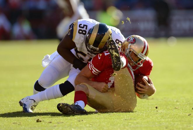 Alex Smith of the San Francisco 49ers is hit hard by Jo-Lonn Dunbar of the St. Louis Ram during the first quarter of their game on Sunday.