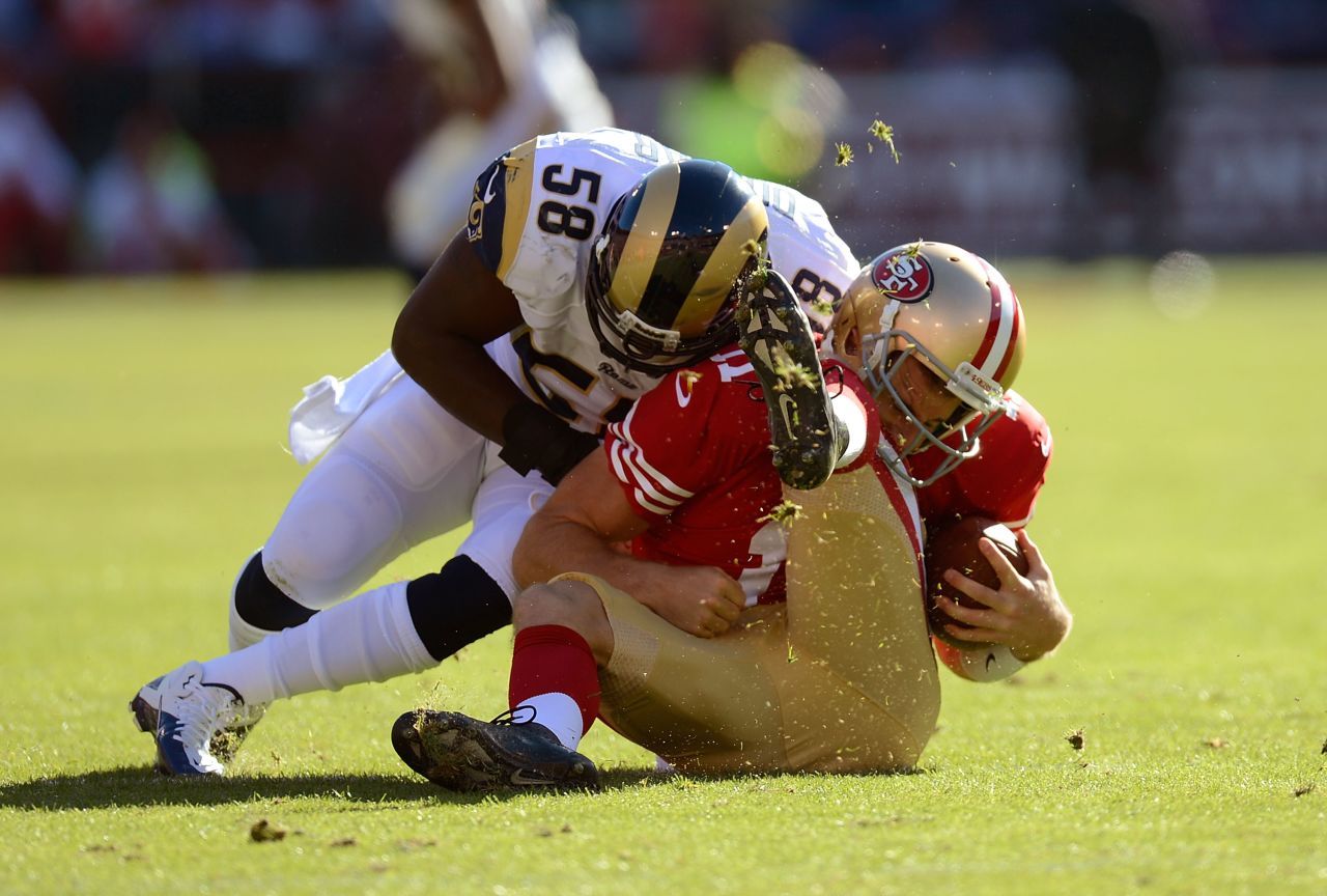 Alex Smith of the San Francisco 49ers is hit hard by Jo-Lonn Dunbar of the St. Louis Ram during the first quarter of their game on Sunday. 