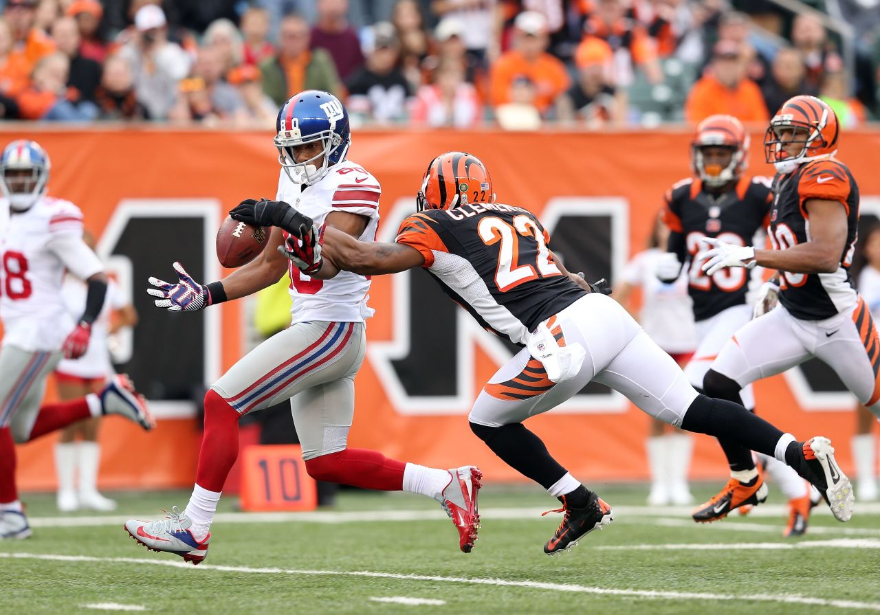 Victor Cruz of the New York Giants drops the ball while defended by Nate Clements of the Cincinnati Bengals at Paul Brown Stadium on Sunday in Cincinnati. 
