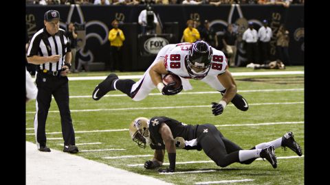 Tony Gonzalez of the Atlanta Falcons dives over Jabari Greer of the New Orleans Saints at Mercedes-Benz Superdome on Sunday in New Orleans.