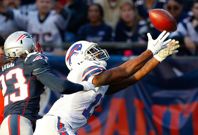 Donald Jones of the Buffalo Bills comes up short on a pass as Marquice Cole of the Patriots defends in the second half of Sunday's game.