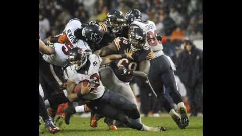 Arian Foster of the Houston Texans is tackled by Henry Melton of the Chicago Bears on Sunday at Soldier Field in Chicago. The Texans defeated the Chicago Bears 13-6.