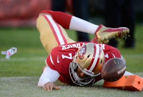 Colin Kaepernick of the San Francisco 49ers dives for the flag and scores on a seven-yard touchdown run against the St. Louis Rams in the fourth quarter at Candlestick Park on Sunday in San Francisco. The game ended after sudden death overtime in a 24-24 tie.  