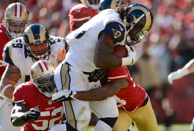 Steven Jackson of the St. Louis Rams drags Dashon Goldson and Patrick Willis of the San Francisco 49ers into the end zone for a seven-yard touchdown run in the first quarter of their game at Candlestick Park on Sunday in San Francisco.