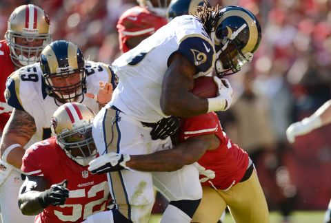 Steven Jackson of the St. Louis Rams drags Dashon Goldson and Patrick Willis of the San Francisco 49ers into the end zone for a seven-yard touchdown run in the first quarter of their game at Candlestick Park on Sunday in San Francisco. 