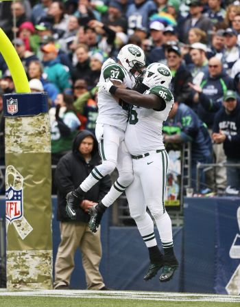 Defensive end Muhammad Wilkerson, right, of the New York Jets celebrates with strong safety Yeremiah Bell after returning a fumble for a touchdown on Sunday.