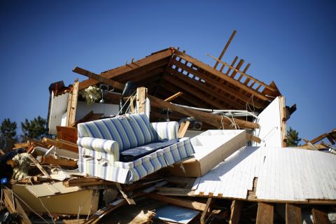 Debris strewen by Superstorm Sandy sits piled outside a damaged home in Mantoloking, New Jersey, on Monday.
