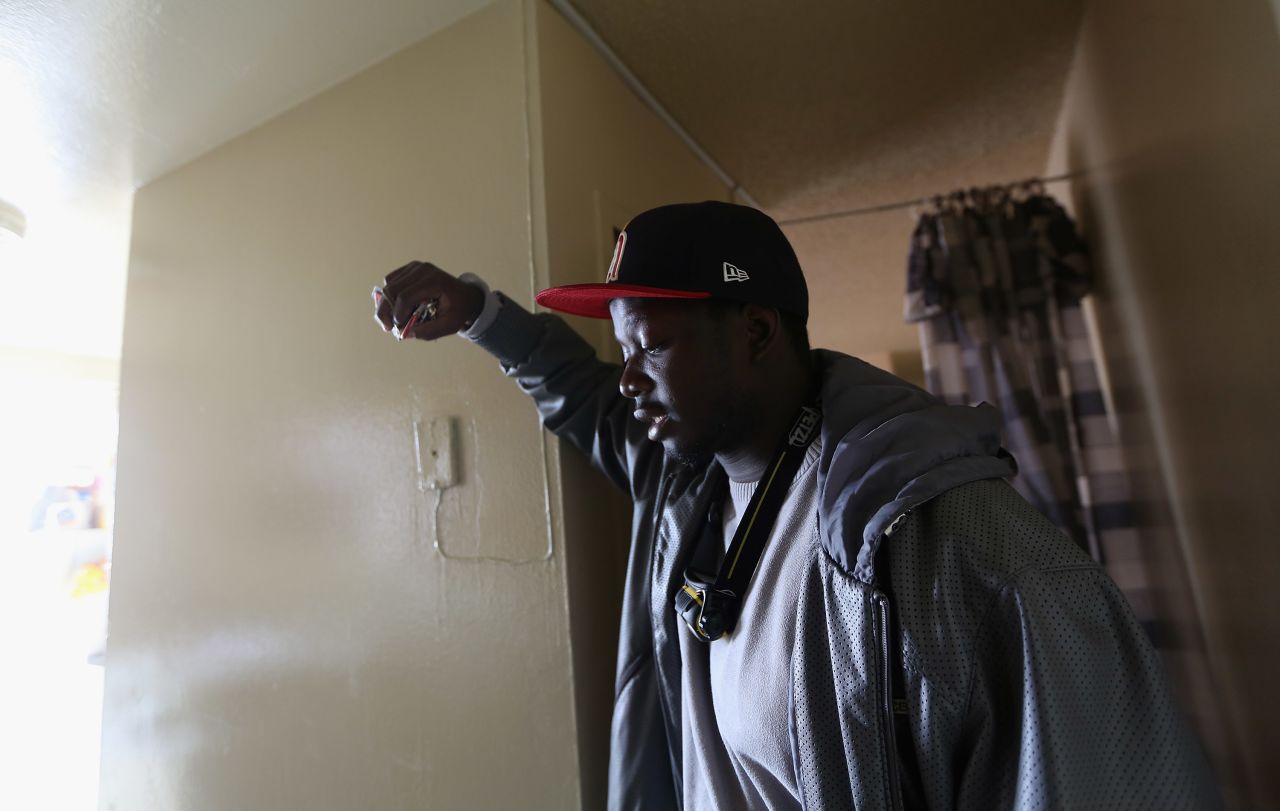 Dale Freeman stands in his water-damaged apartment in a public housing building that still doesn't have power on Monday in Brooklyn. About 58,000 customers in the Rockaways, Long Island and Brooklyn require more extensive repairs before electricity can be restored. 