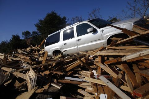 An SUV sits atop the debris from a home in Mantoloking, New Jersey, on Monday.