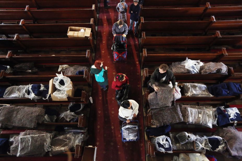People line up to receive donated items from Catholic Charities of Brooklyn and Queens at Visitation of the Blessed Virgin Mary Catholic Church in Brooklyn on Monday.
