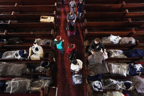 People line up to receive donated items from Catholic Charities of Brooklyn and Queens at Visitation of the Blessed Virgin Mary Catholic Church in Brooklyn on Monday.
