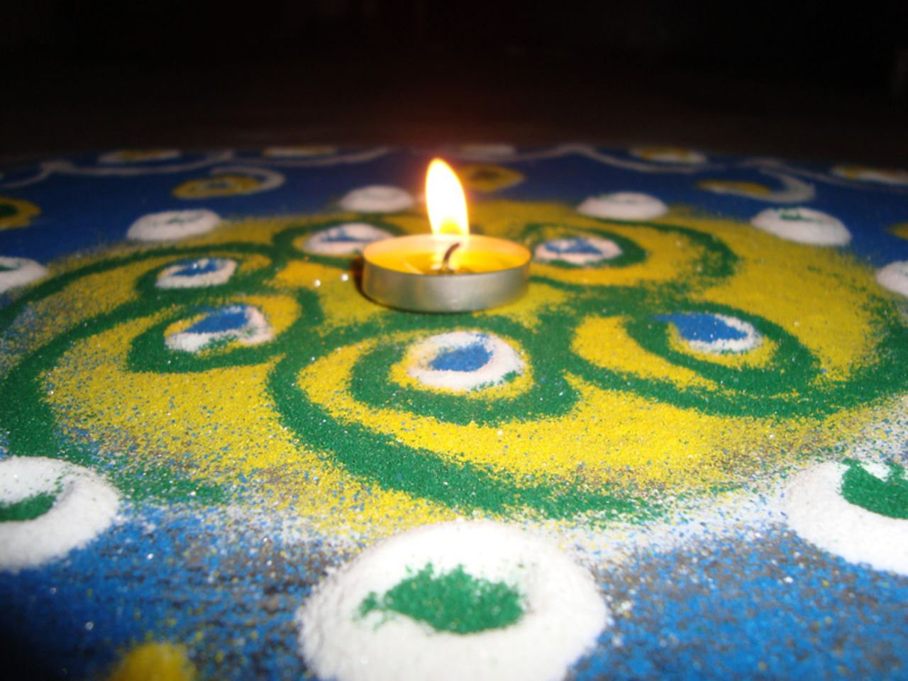 Diwali is a festival that provides the opportunity to celebrate life with colors as well as lights, says <a href="http://ireport.cnn.com/people/deadspirit6">Dinesh Thakur</a> of Pune, India. "It symbolizes victory of good over evil - light defeating darkness. It teaches us to have faith in the 'good' and not give into the darkness," he adds. He took this image of a single candle resting above a rangoli artwork to mark the start of this year's festival.