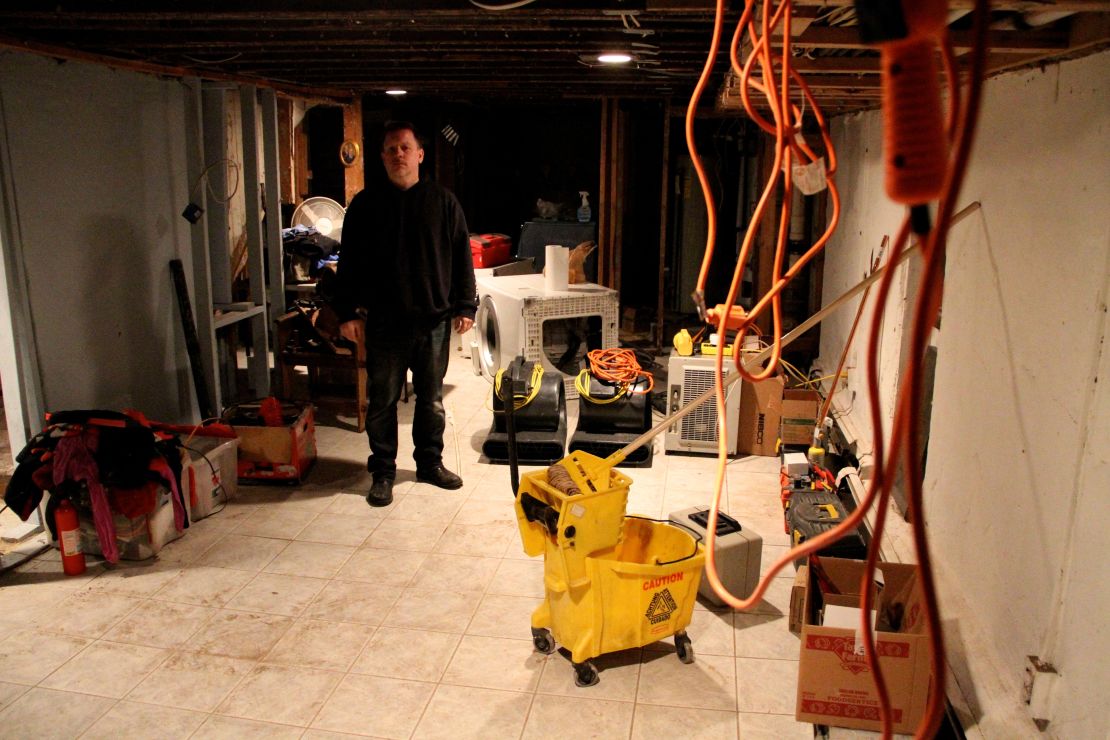 Jeff Spangler works in his basement after losing thousands of dollars worth of property from Superstorm Sandy.