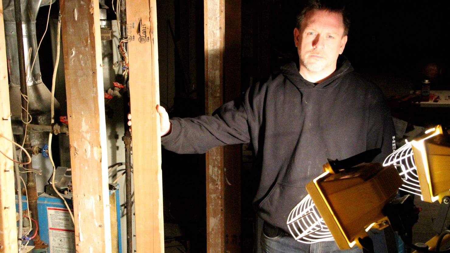 Jersey City resident Jeff Spangler works by floodlight in his basement, which was destroyed by Superstorm Sandy.