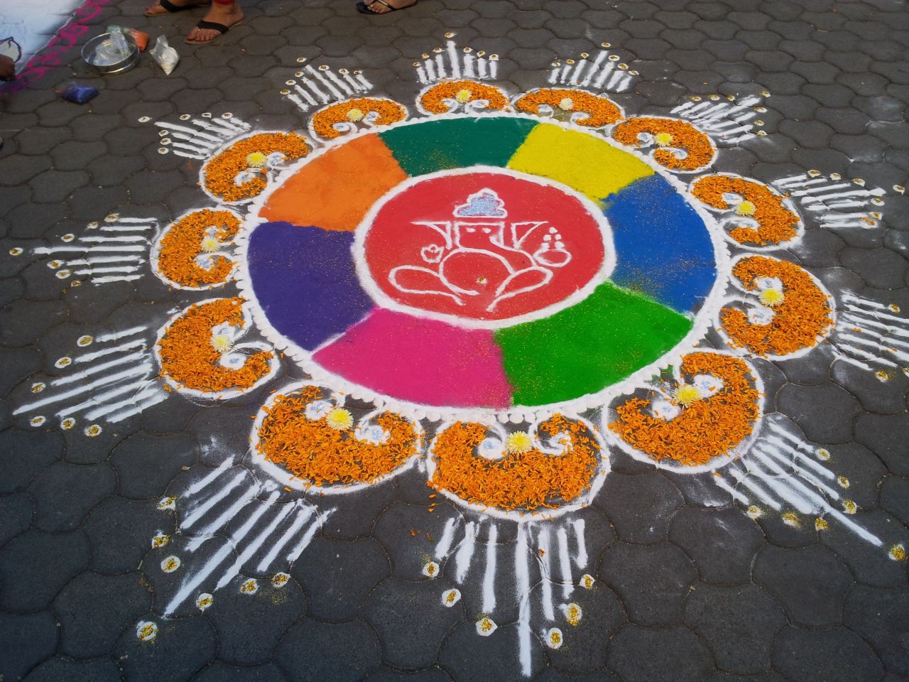 A rangoli artwork, as created and captured by iReporter <a href="http://ireport.cnn.com/people/indtechieguy">Kshitij Sharma</a>, adorns a sidewalk in Pune, India. "I think this festival reminds us to stay away from bad things and to promote communal harmony," he says. "The main highlight is of course the lights, at night whole cities and towns look lovely because of the lights."