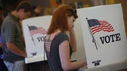 Student Courtney Johnson (R) votes on the campus of the University of Northern Iowa on September 28, 2012.