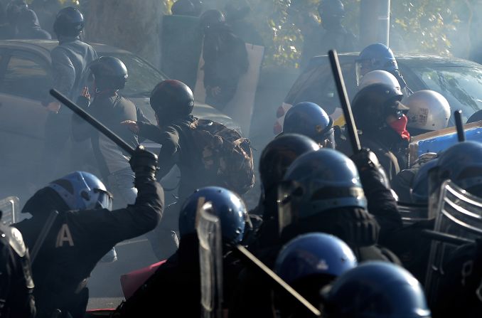 Riot policemen fight demonstrators in Rome.