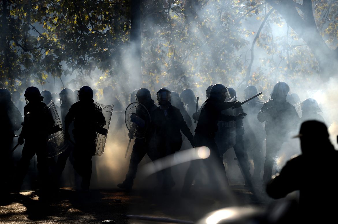 Demonstrators fight riot policemen during a protest against austerity measures in Rome.