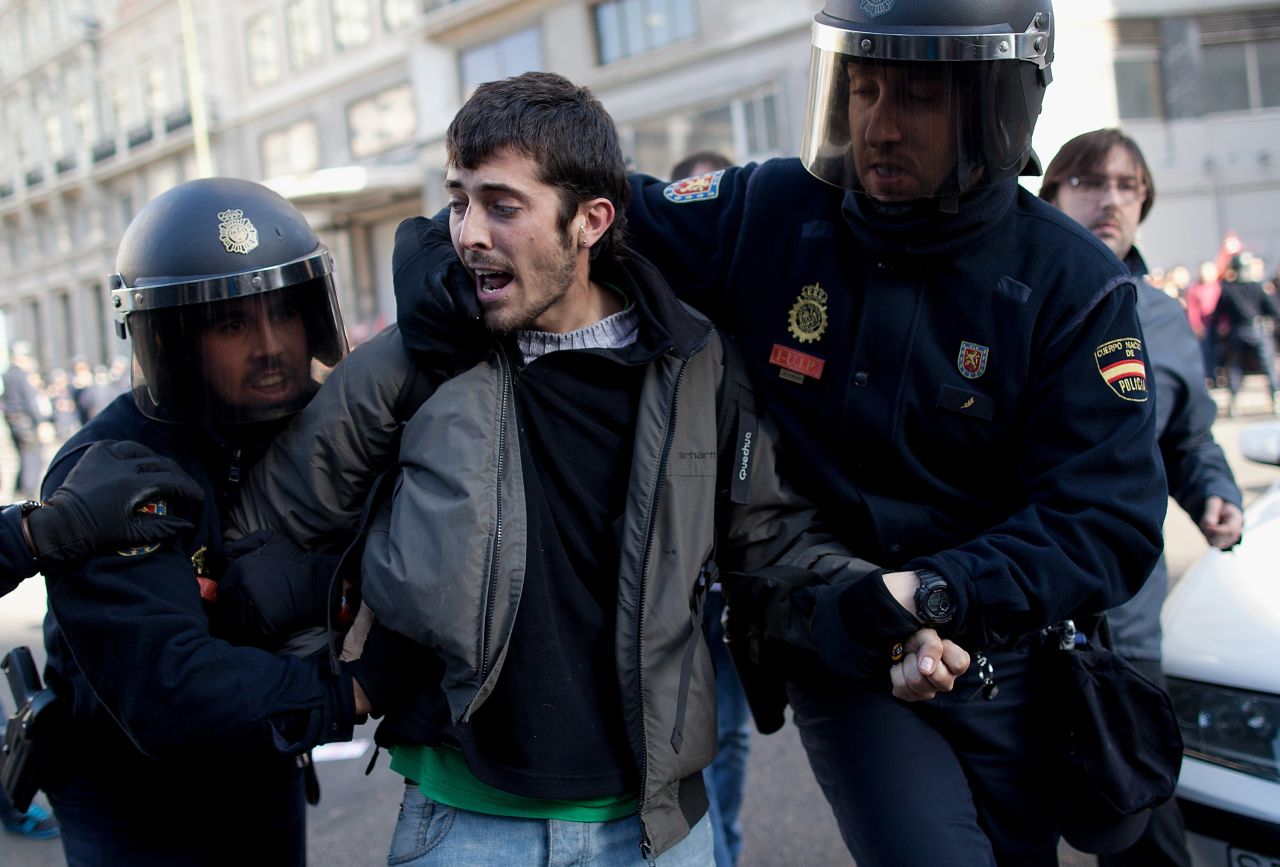 Riot police arrest a protester at Gran Via in Madrid, Spain.
