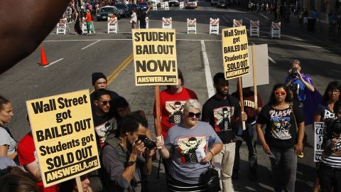 Demonstrators symbolically "burn" student loan bills in Los Angeles during a protest of rising student loan costs.