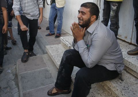 A Palestinian man cries as security forces wheel al-Jaabari's body into a hospital.