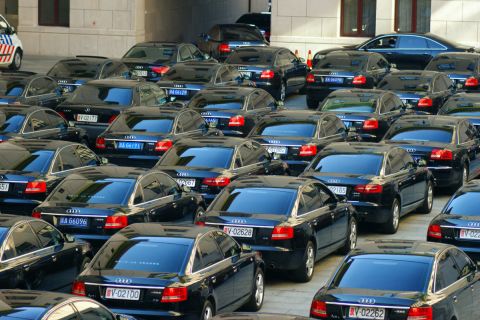 Cars for delegates to the party congress are pictured near the Great Hall of the People, mostly black  Audis.  