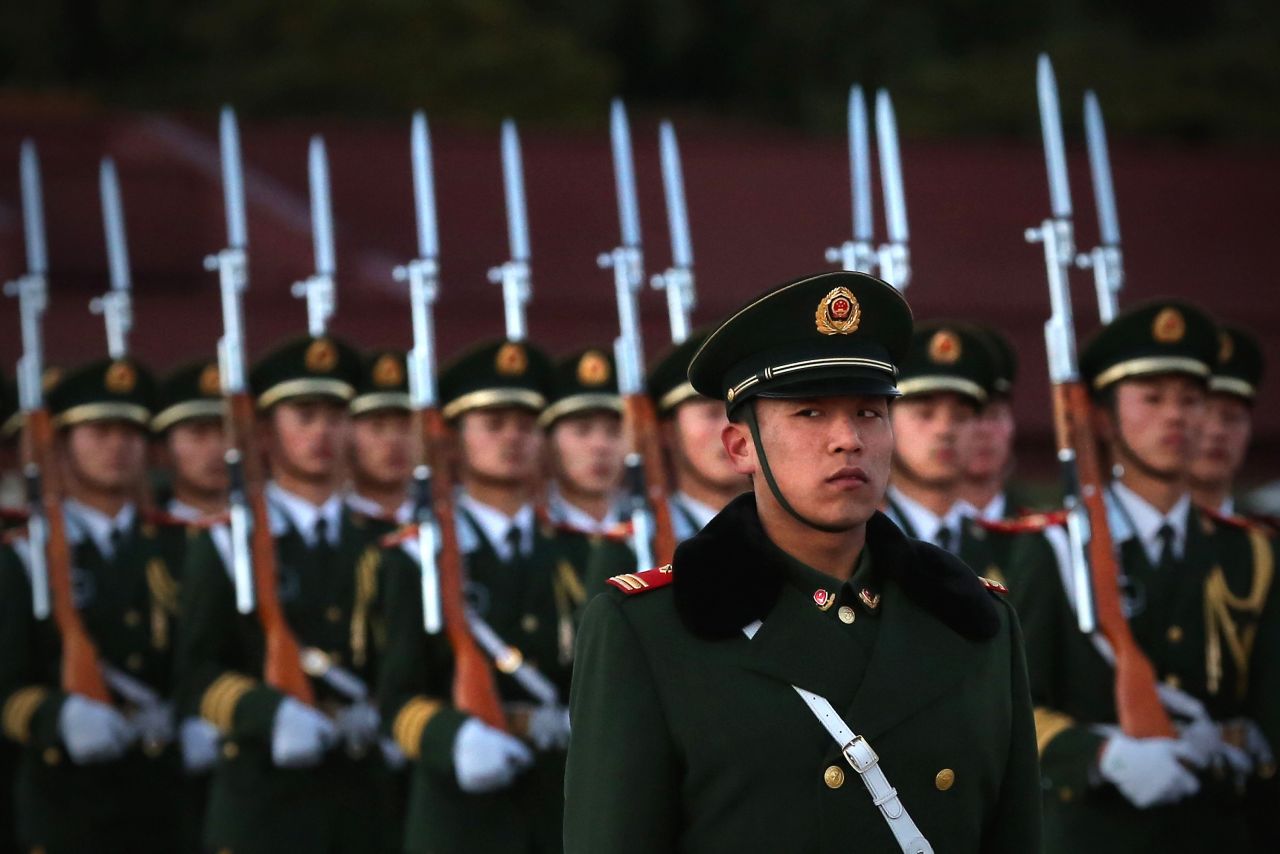 A paramilitary police officer stands guard during the flag-lowering ceremony at  Tiananmen Square on November 13.