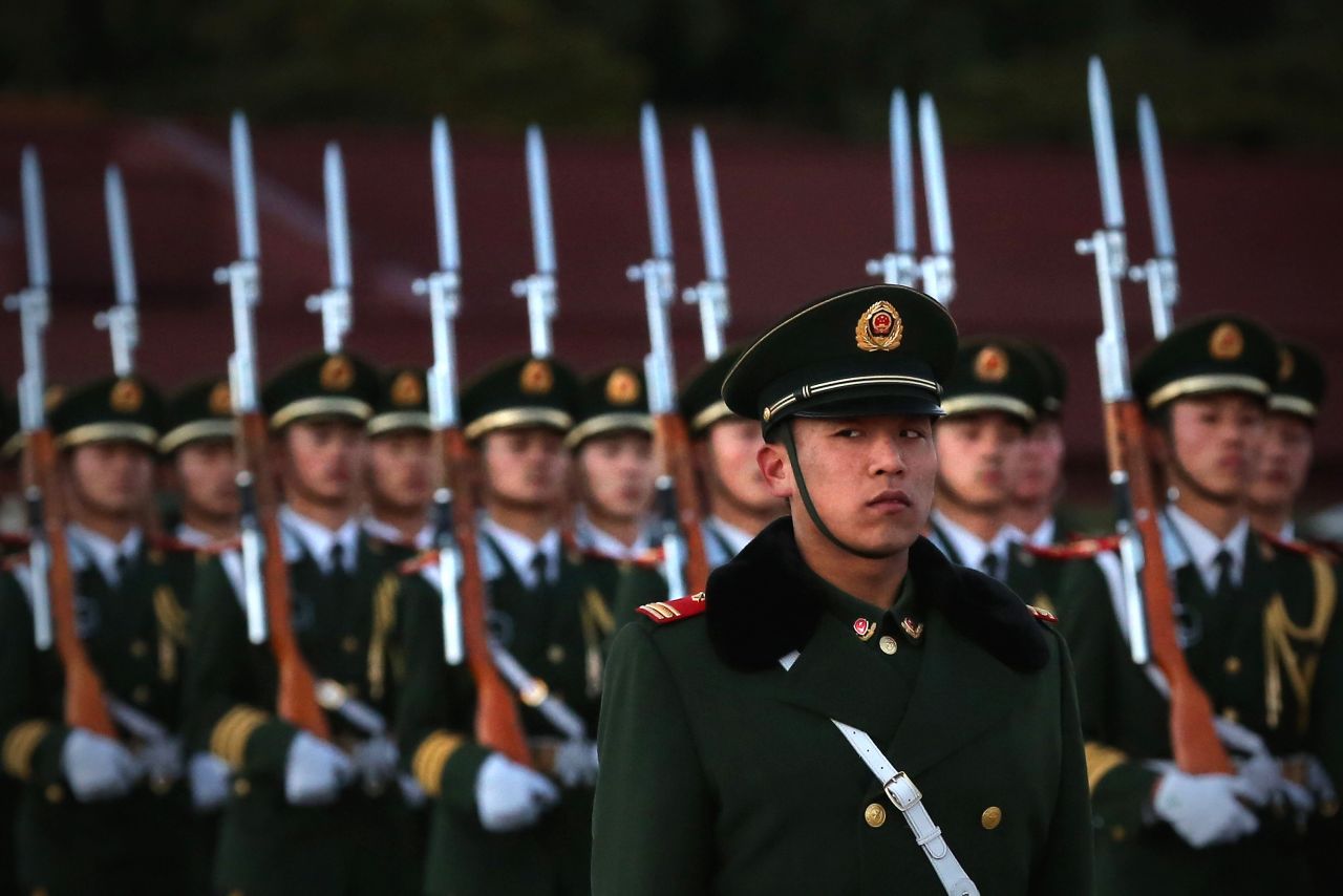A paramilitary police officer stands guard during the flag-lowering ceremony at Tiananmen Square on November 13.