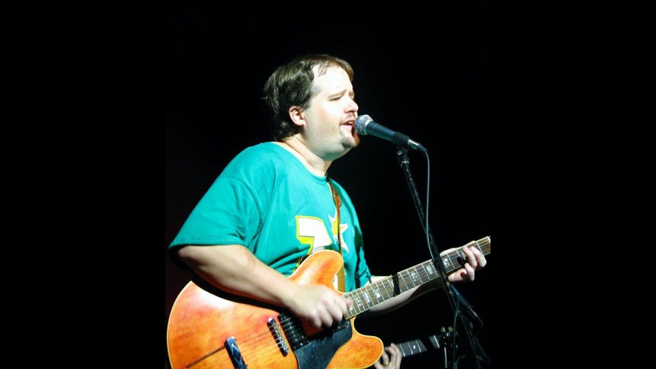 Steve Rummler playing guitar with his band, The Goonybirds, at a ski resort in 2002.