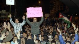 Jordanian protestors hold up banners and their national flag during a demonstration in Amman following an announcement that Jordan would raise fuel prices, including a 53 percent hike on cooking gas, on November 13, 2012. Trade and Industry Minister Hatem al-Halwani decided to adjust the price of fuel, raising the cost of household gas from 6.5 dinars to 10 dinars per cylinder, a 53 per cent rise, state TV said.