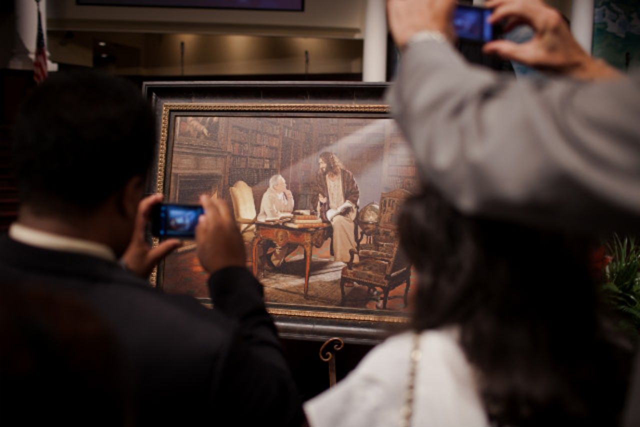 Churchgoers crowd around a picture of the Rev. Charles Stanley given to him at a service.