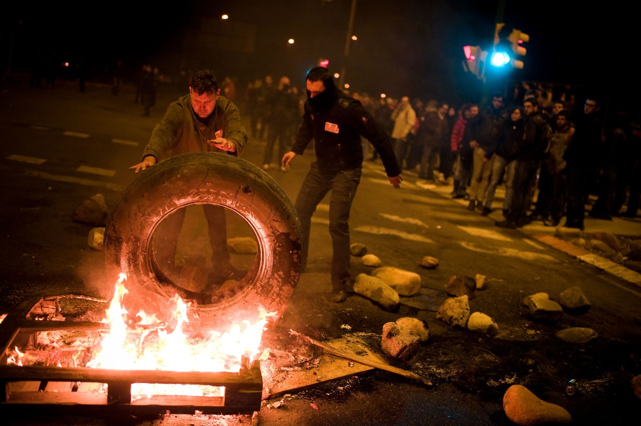 In Barcelona, demonstrators set up a barricade of burning tires.