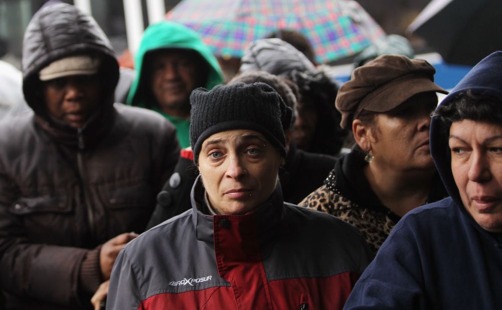 People wait in line to collect some of the 1,500 donated coats from New York Cares on Tuesday in Queens.  The charity started its annual coat drive early this year to assist those affected by Superstorm Sandy. It hopes to collect 200,000 coats this winter.