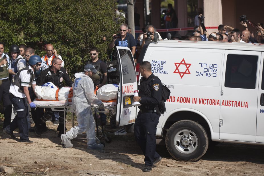 Rescue workers evacuate a body Thursday, November 15, in the Israeli town of Kiryat Malakhi after a rocket launched from Gaza hit an apartment building. 