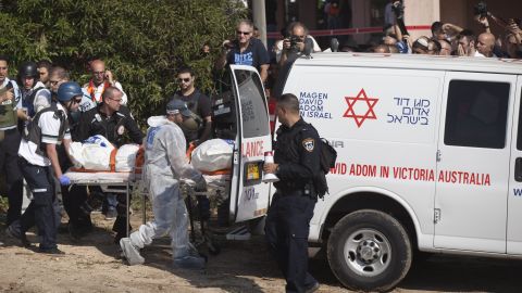 Rescue workers evacuate a body Thursday, November 15, in the Israeli town of Kiryat Malakhi after a rocket launched from Gaza hit an apartment building.