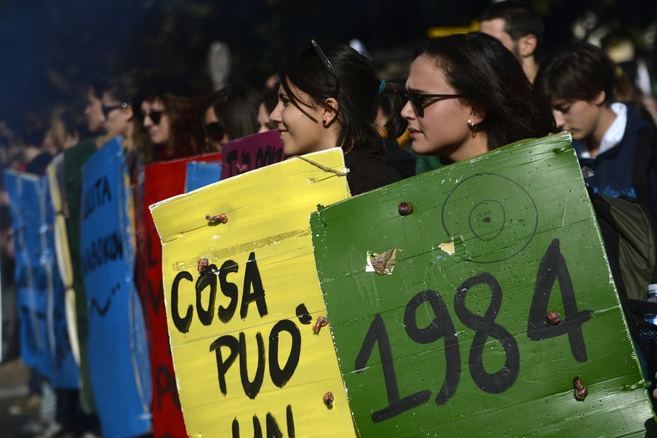 Students hold placards with titles of classic books during a protest on a day of mobilization against austerity measures by workers in southern Europe on November 14, 2012 in Rome.