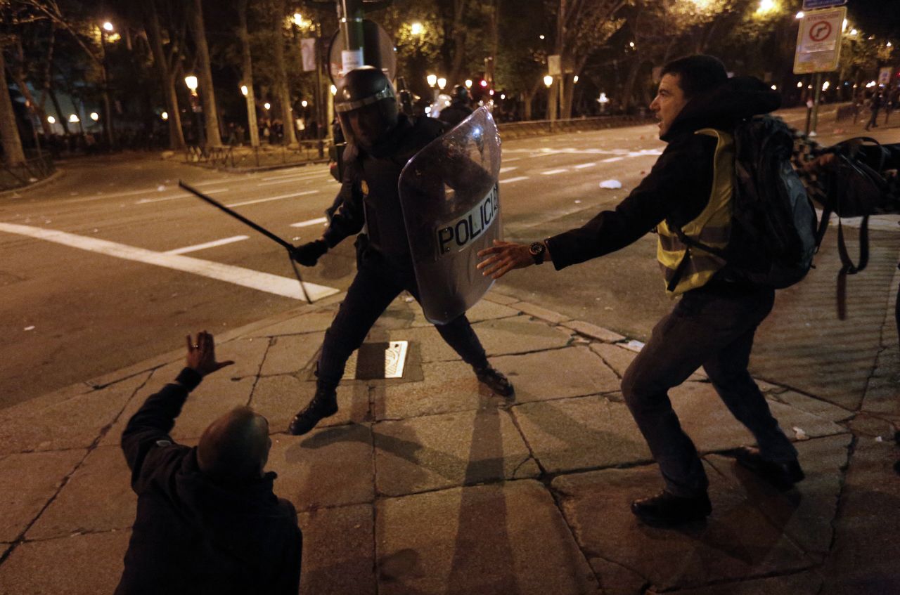 A police officer clashes with protesters Wednesday in Madrid. Spain is experiencing its second general strike in a year, and some of Europe's largest and occasionally violent protests took place there.