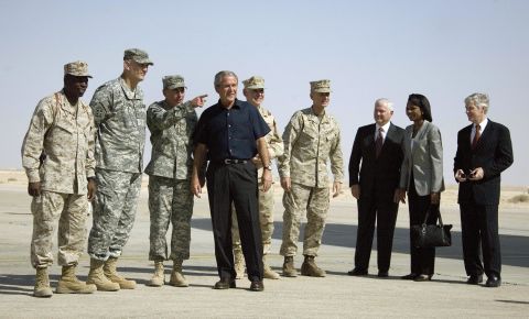 Petraeus, third from left, listens as President George W. Bush speaks at Al Asad Air Base in Anbar Province, Iraq, in September 2007. From the right, U.S. Ambassador to Iraq Ryan Croker, Secretary of State Condoleezza Rice and Defense Secretary Robert Gates, who arrived with Bush, look on.