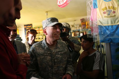 Petraeus speaks with store owners in the Ghazaliya neighborhood in Baghdad in August 2007.