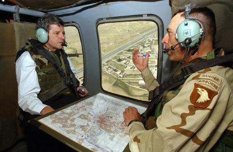 Petraeus served as commanding general of the 101st Airborne Division U.S. Army between 2002 and 2004 and led troops into battle  when the U.S. invaded Iraq in March 2003. Pictured, Petraeus speaks with  Paul Bremer, the new U.S. overseer in Iraq, during a helicopter tour of Mosul, Iraq, in May 2003.
