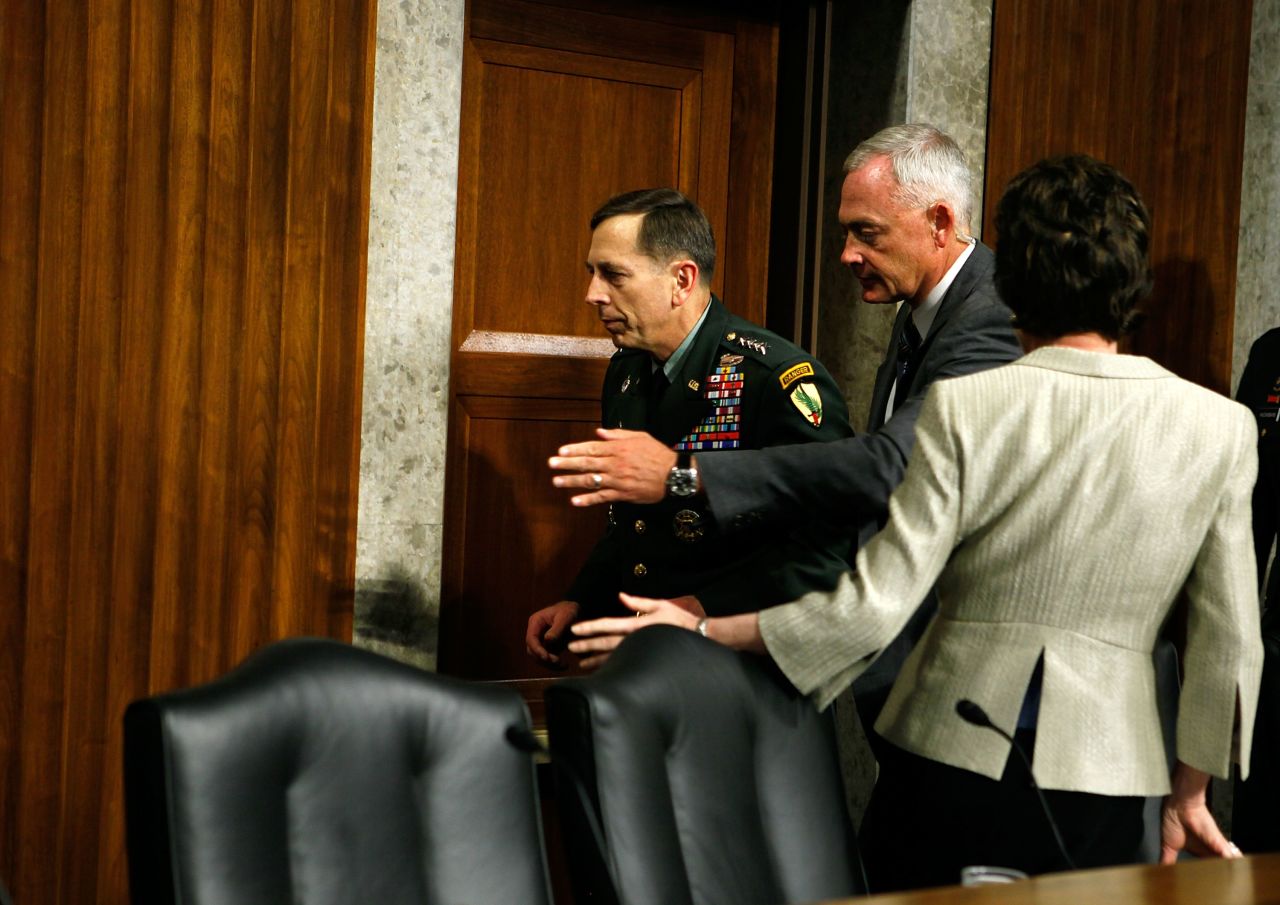 Petraeus apparently faints while testifying during a hearing before the Senate Armed Services Committee in June 2010 in Washington. Pictured, he is escorted away after the incident.