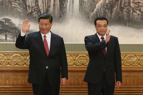 Chinese Vice President Xi Jinping and Chinese Vice Premier Li Keqiang, two of the members of the new seven-seat Politburo Standing Committee, greet the media at the Great Hall of the People on November 15.   