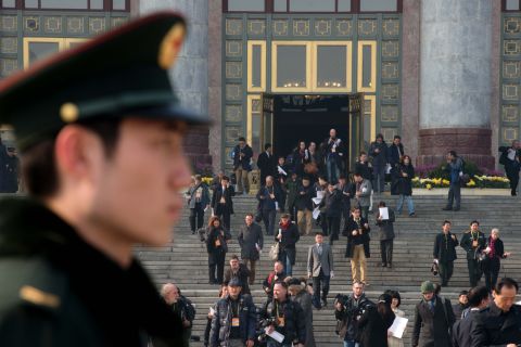 A paramilitary guard stands outside the Great Hall of the People as journalists leave the unveiling ceremony of a new Politburo Standing Committee on November 15.