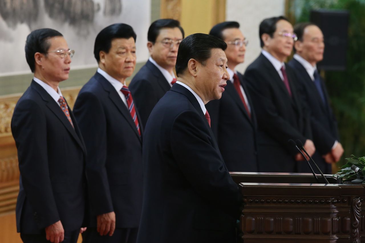Xi Jinping  delivers a speech as the rest of the new Politburo Standing Committee looks on.
