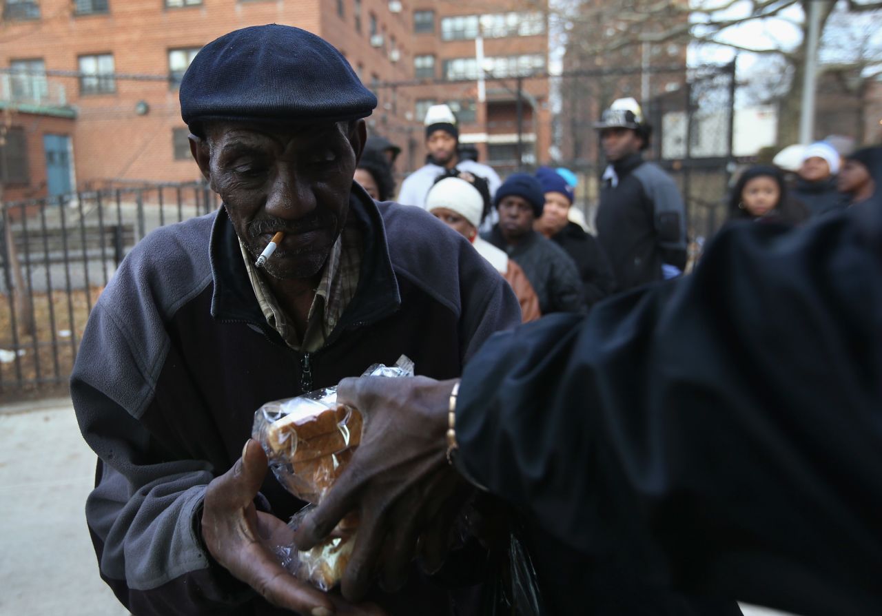 People receive free sandwiches from a mobile food distribution center in the Rockaway neighborhood of Queens, New York, on Thursday.