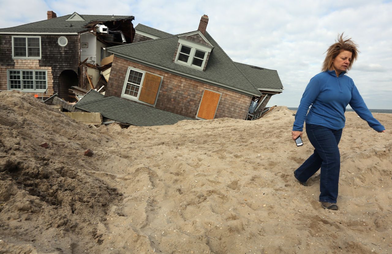 Lisa Baney walks back toward her family's home in Bay Head, New Jersey, after taking a photo of a neighbor's destroyed house Wednesday, November 14.