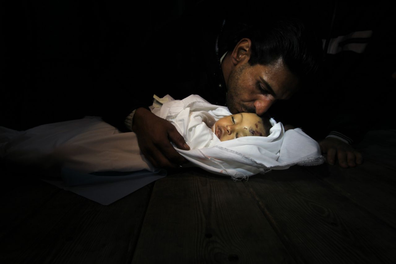 Palestinian relatives mourn over the body of Hanen Tafish, a 10-month-old girl, at the morgue of the al-Shifa hospital in Gaza City on Thursday, November 15, after she died following an Israeli air strike in the Zeitun neighbourhood.