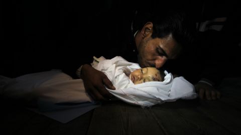 Palestinian relatives mourn over the body of Hanen Tafish, a 10-month-old girl, at the morgue of the al-Shifa hospital in Gaza City on Thursday, November 15, after she died following an Israeli air strike in the Zeitun neighbourhood.