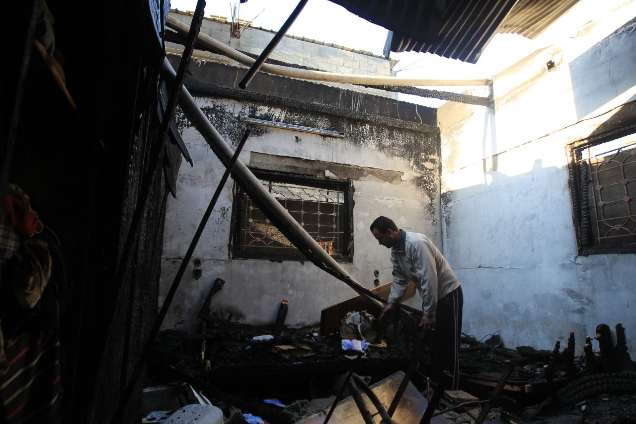 A Palestinian man inspects his damaged house following an Israeli airstrike early Thursday, November 15, in Gaza City.